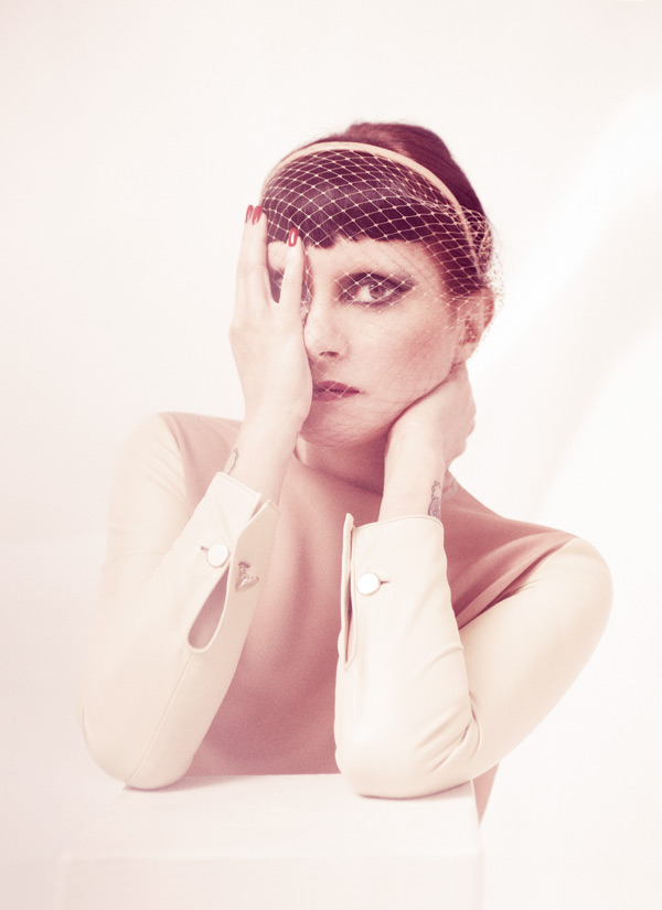 Julia loves to dress up. She was photographed at Curtain Road Studios in East London in a selection of striking looks chosen by stylist Jodie Barnes. Here, Princess Julia is wearing a nude silk dress with cream leather sleeves by CÉLINE. Her nude voilette headband is by JENNIFER BEHR.